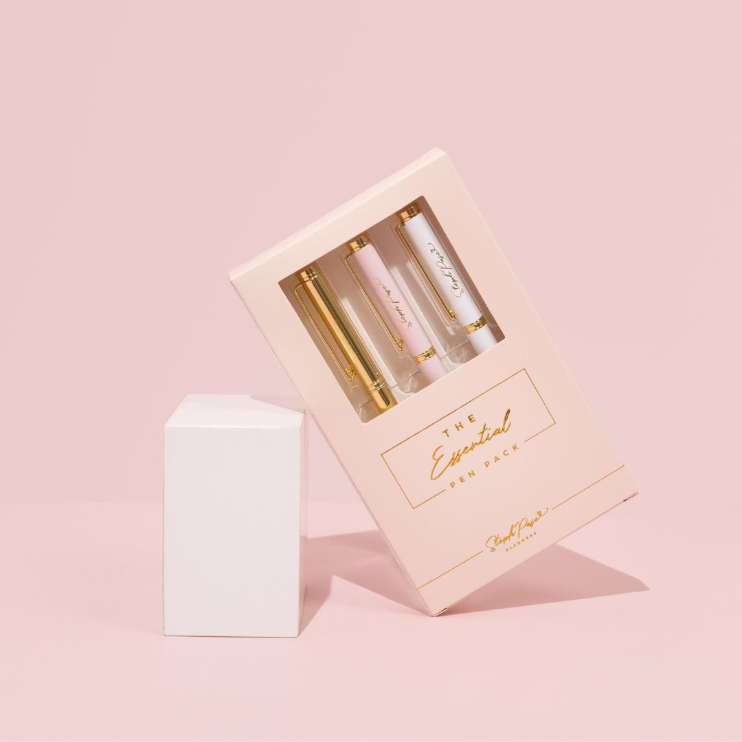 A pack of premium ballpoint pens in white metal, pink metal and gold metal.