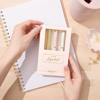 A pack of premium ballpoint pens in white metal, pink metal and gold metal.