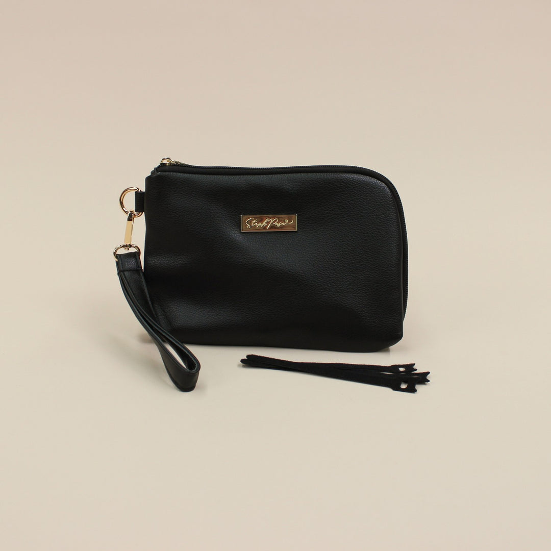 Black faux leather cable organiser bag with zip, removable strap, tech loops and multiple storage pockets.